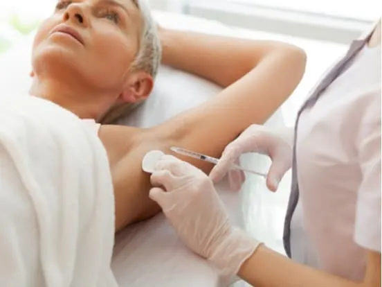 syringe being filled with special liquid for anti sweating treatment